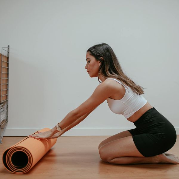 Roll of yoga mat on a clean floor